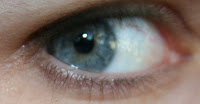 Photo of a blue eye with an undilated pupil.