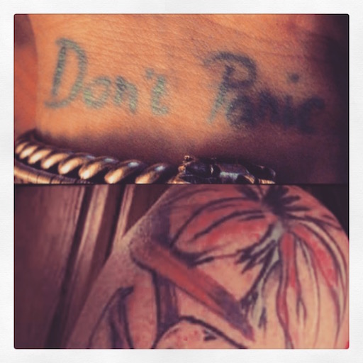 Pictures of tattoos. One reads Don't Panic.