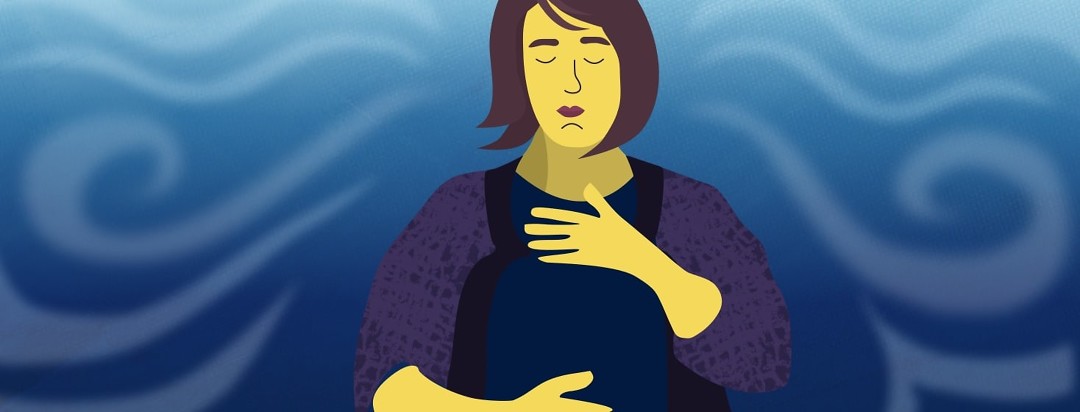 Woman with hand on chest and stomach performing a breathing exercise.