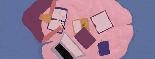 a person with their books and laptop computer spread out on a brain shaped table.