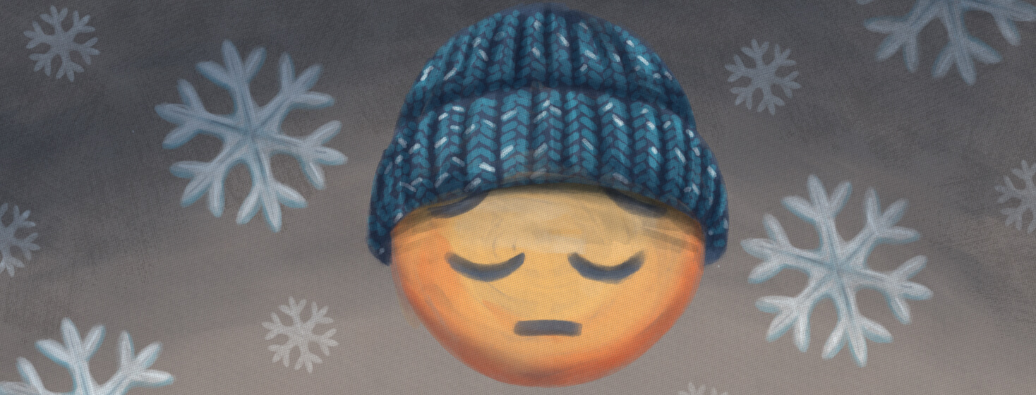 Emoji with knitted hat frowns amid a dark dusty snowflake sky