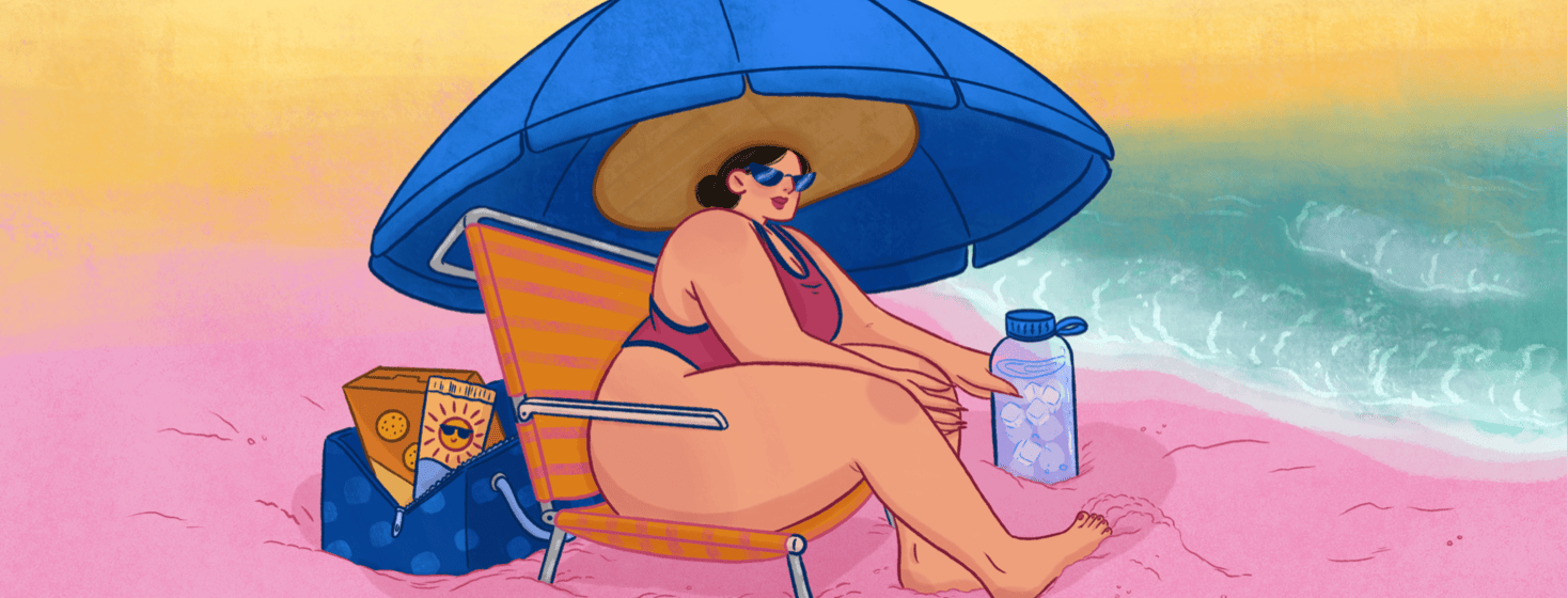 A woman wearing a wide sunhat sits under an umbrella at the beach; she has a large bottle of water and a bag behind her with snacks and sunscreen