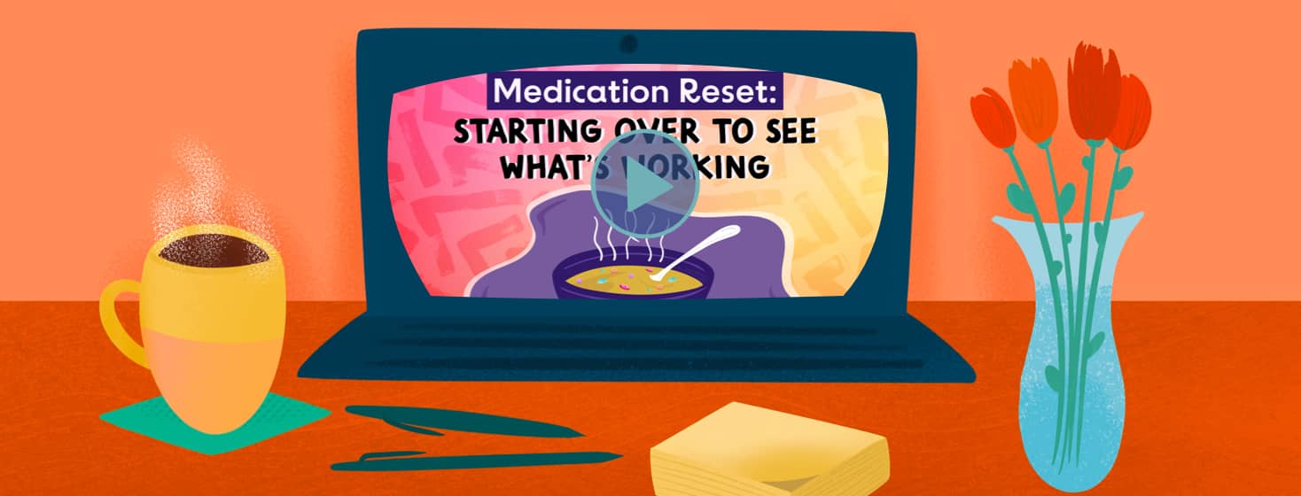 A coffee, two pens, a pad of sticky notes, and a vase of flowers are in front of a laptop displaying a video called "Medication Reset: Starting over to see what's working"