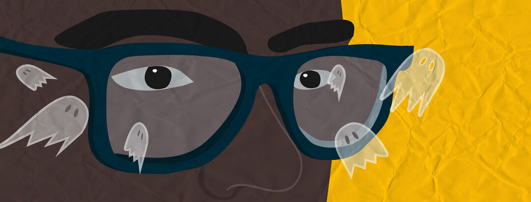 A man wearing glasses and seeing ghosts in his field of vision