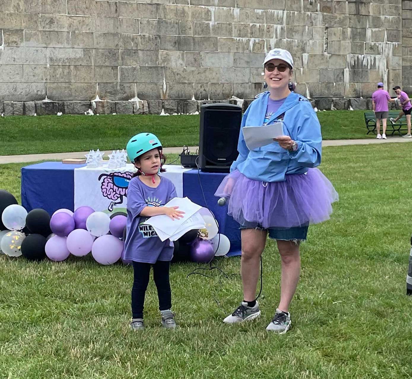 Lisa stands next to her daughter at an awareness event.