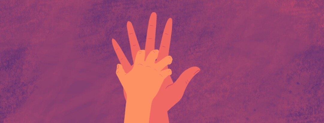 A child's hand reaches up to grab a parent's open hand.